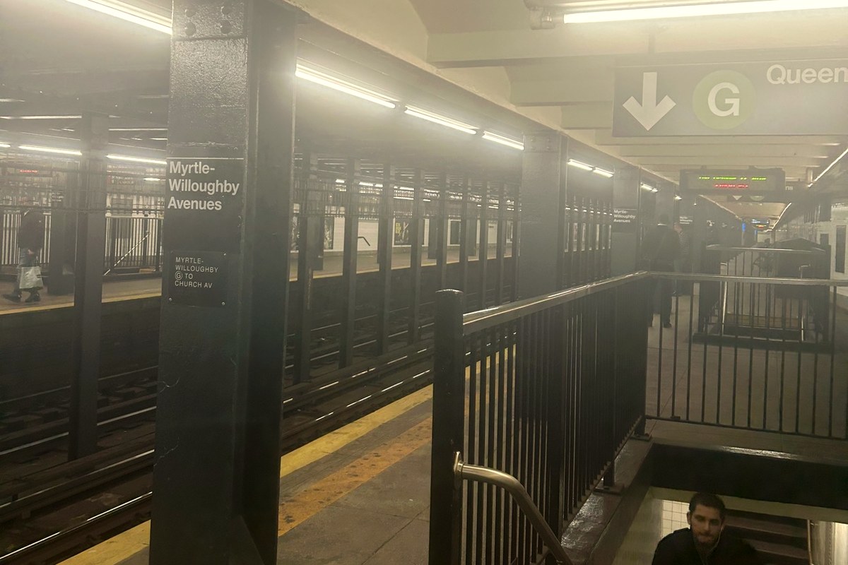 The Myrtle-Willoughby Avenues station on the G line in Brooklyn, the station name on a platform pillar and a G sign overhead
