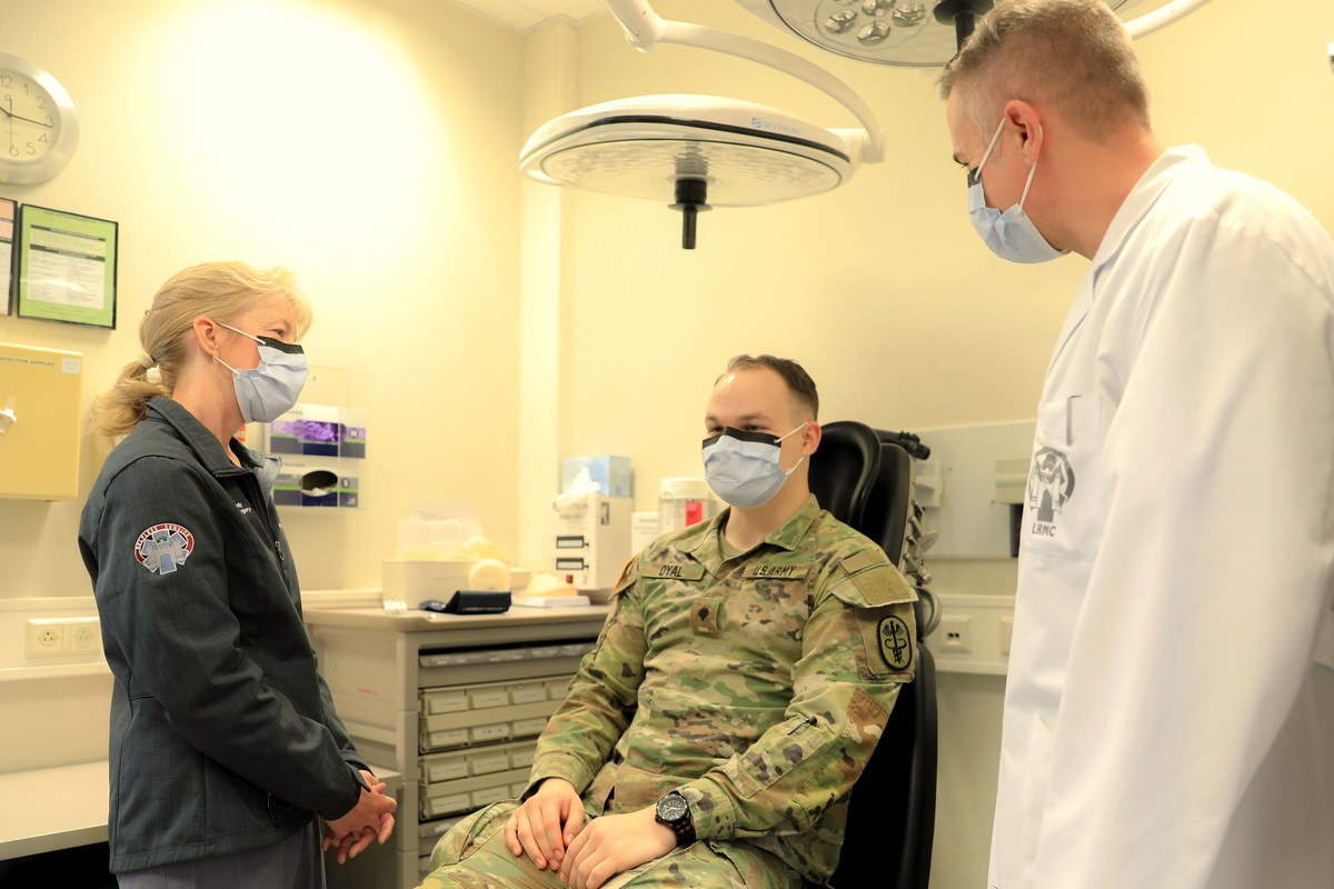 A nurse preparing a patient for a medical exam at a clinic
