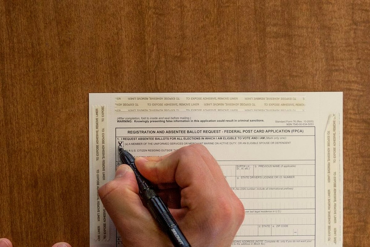 New York National Guard soldiers filling out federal ballot application forms while deployed